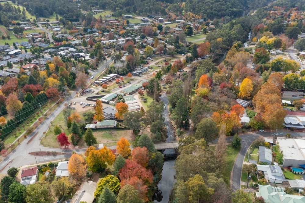 Image of Aerial view of river running through a regional town full of ...