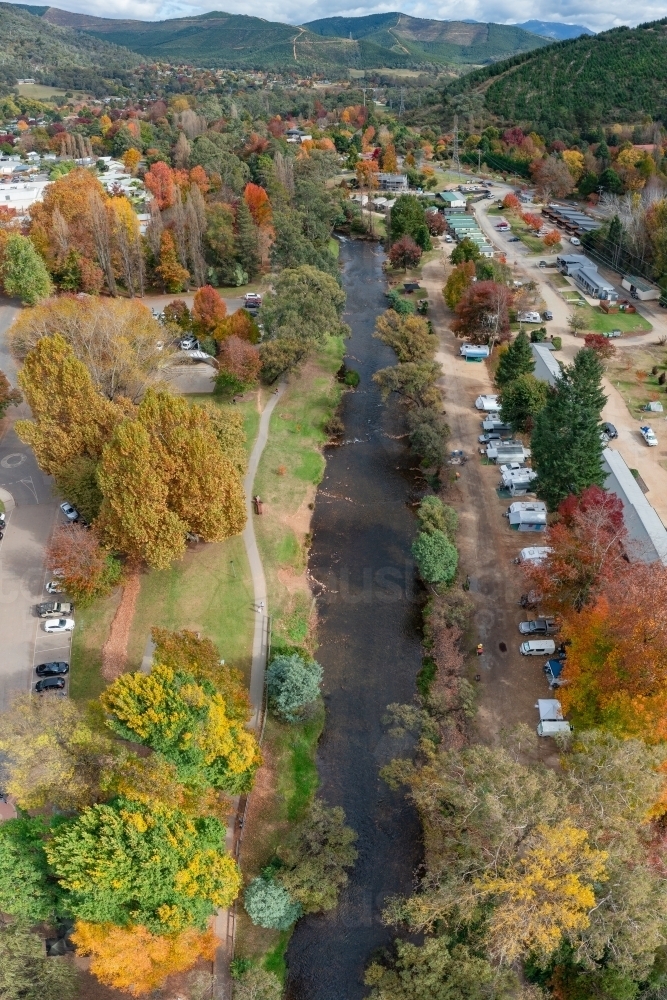 Image of Aerial view of river running through a regional town full of ...