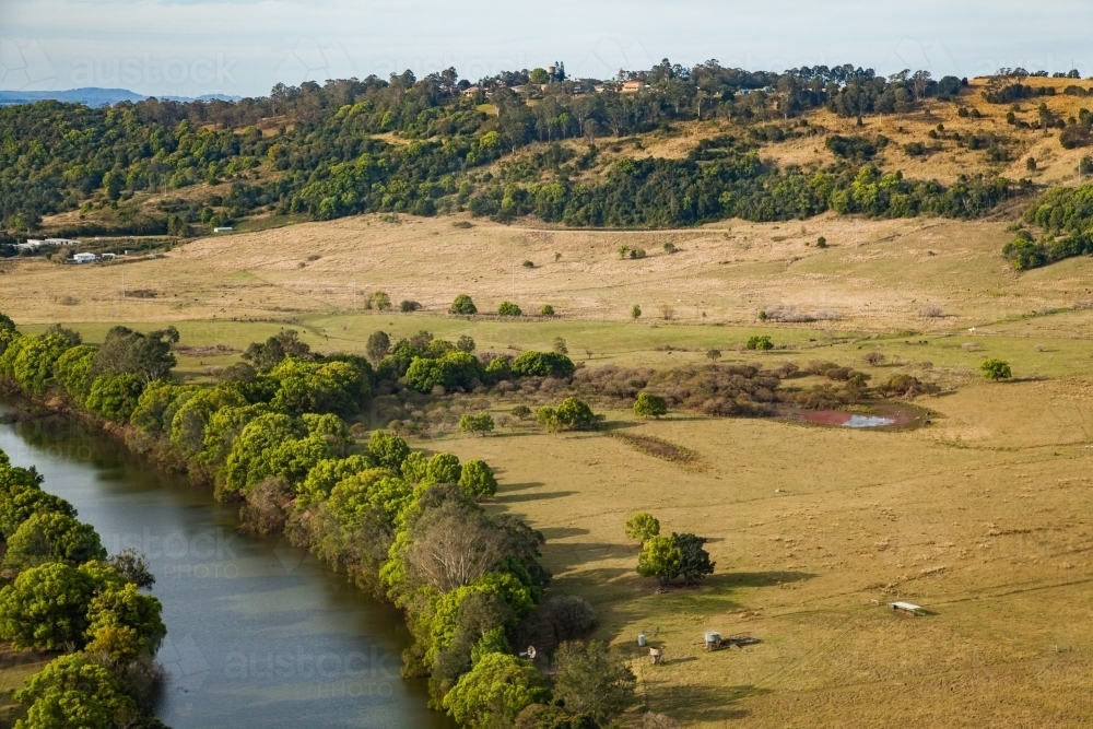 Aerial view of river winding through farm land in the country - Australian Stock Image