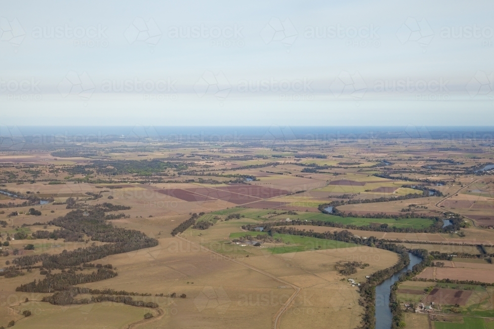 Aerial view of river winding through farm land in the country - Australian Stock Image