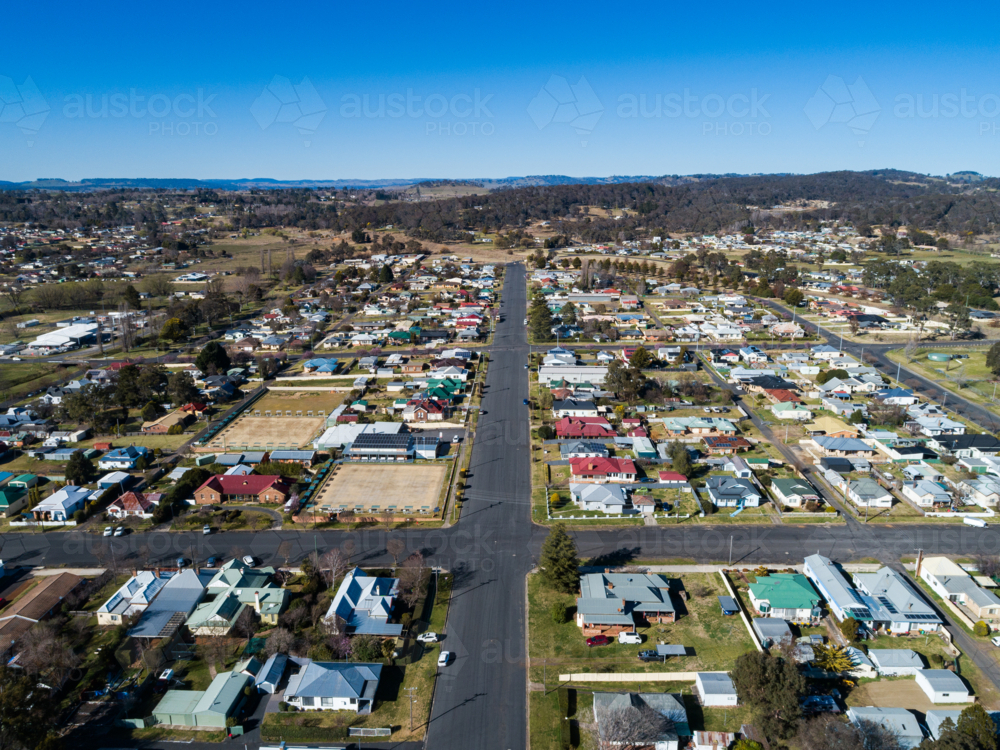 Aerial view of road out of rural town lined with homes in Glen Innes Australia - Australian Stock Image