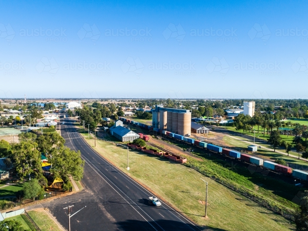 aerial view of road through Narromine with trainline, silos and container train - Australian Stock Image