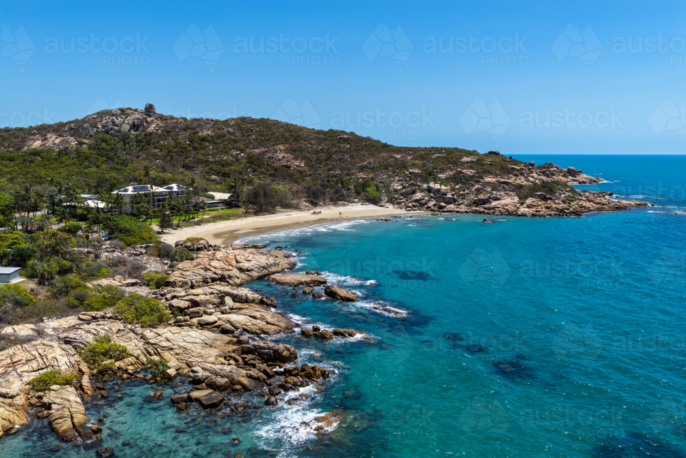 aerial view of Rose Bay in Bowen, Queensland, showcasing turquoise waters and rocky headland - Australian Stock Image