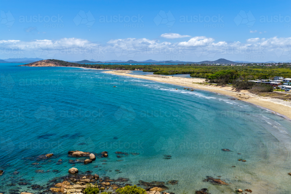 aerial view of Rose Bay in Bowen, Queensland, showcasing turquoise waters and rocky headland - Australian Stock Image