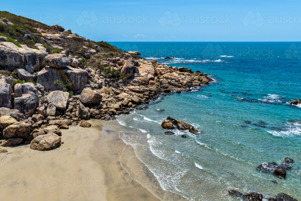 aerial view of Rose Bay in Bowen, Queensland, showcasing turquoise waters and rocky headland - Australian Stock Image
