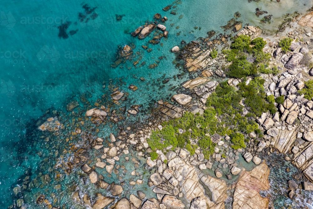 Aerial view of Rose Bay in Bowen, showcasing its rocky shoreline and turquoise waters - Australian Stock Image