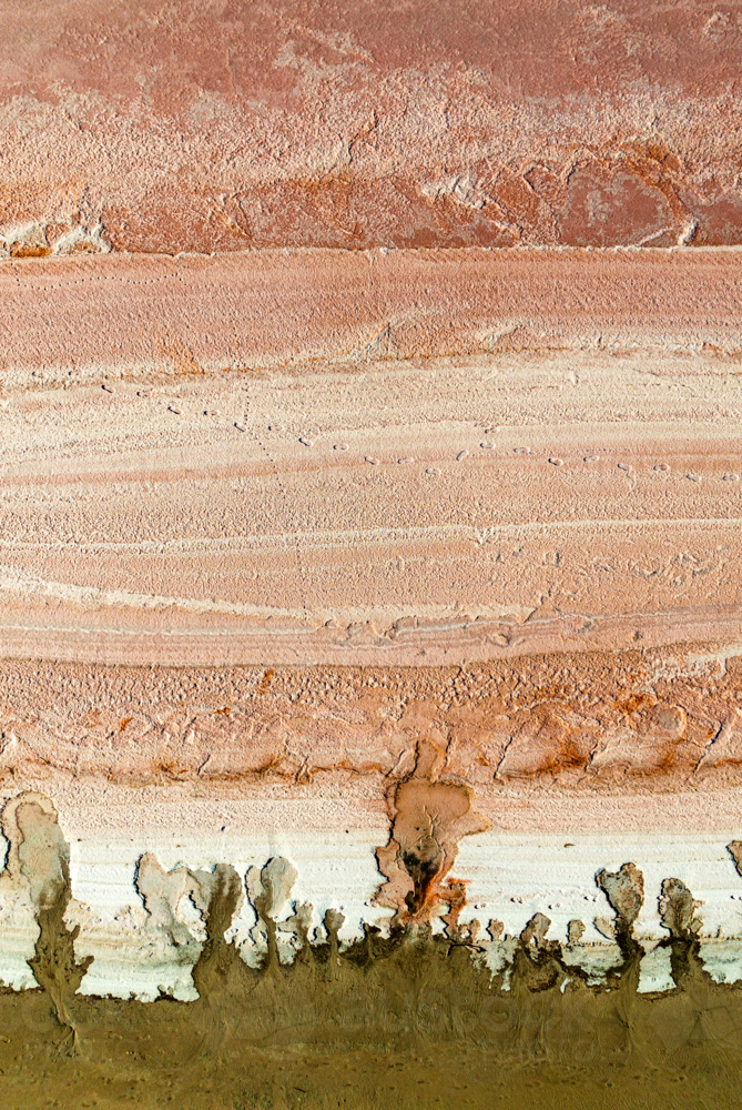 Aerial view of salt textures and mineral bands in warm earthy tones - Australian Stock Image
