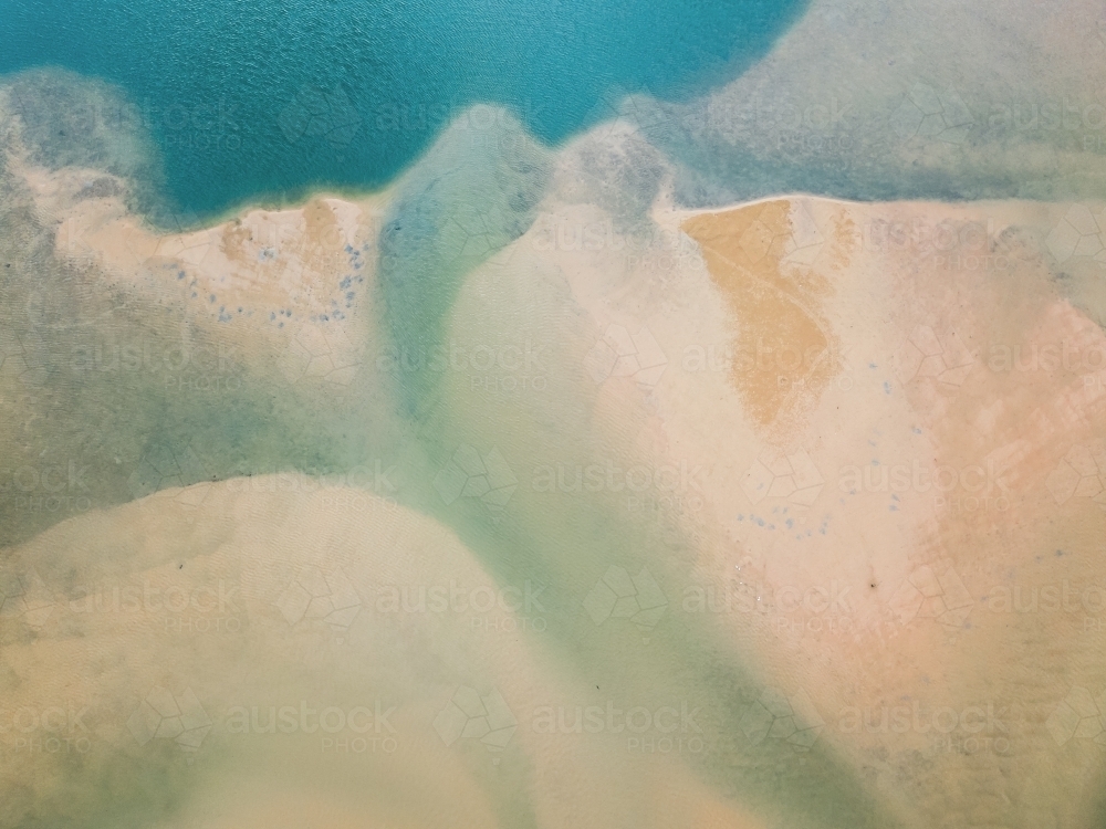 Aerial view of sand and water patterns of a tidal estuary - Australian Stock Image