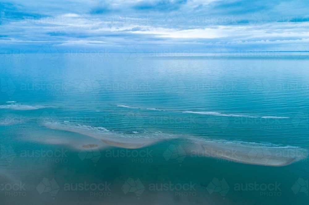 Image of Aerial view of sandbar patterns in shallow blue water ...