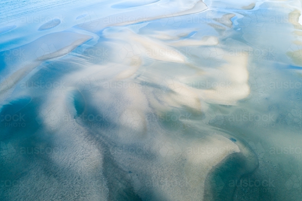 Image of Aerial view of sandbar patterns in shallow blue water ...