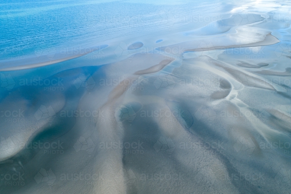 Image of Aerial view of sandbar patterns in shallow blue water ...