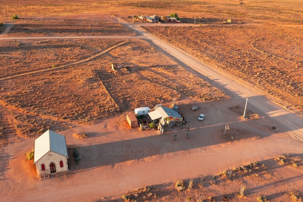 Aerial view of scattered buildings in a arid desert landsacpe - Australian Stock Image