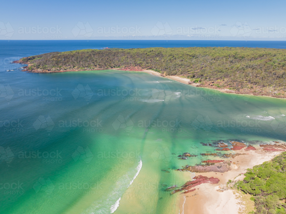 Image of Aerial view of sea waves rolling into a coastal river mouth ...
