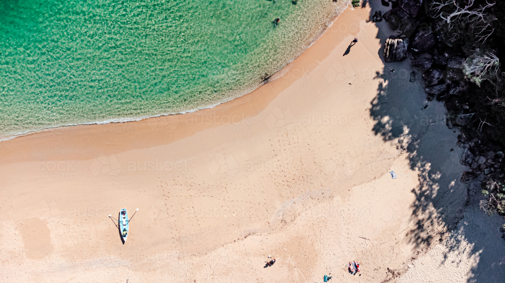 Aerial View of Secluded Beach Cove with Clear Turquoise Water and kayak - Australian Stock Image