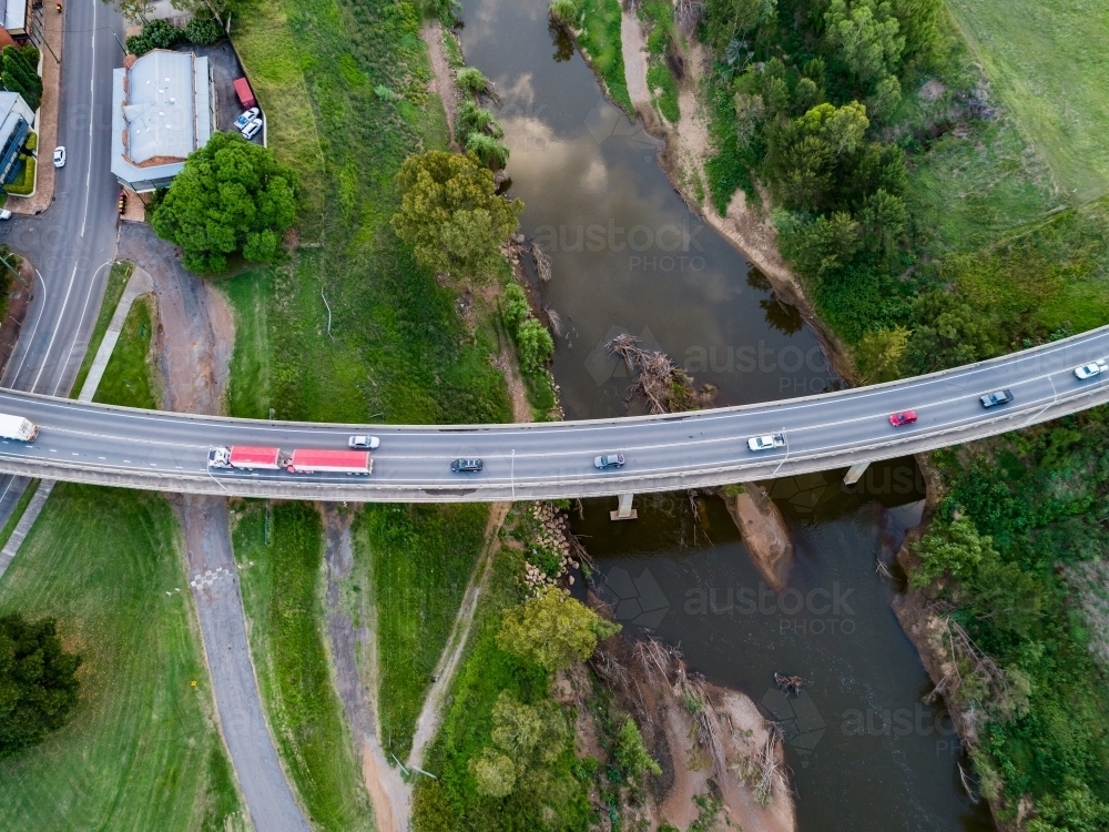 Image of Aerial view of semi truck and cars driving over bridge ...