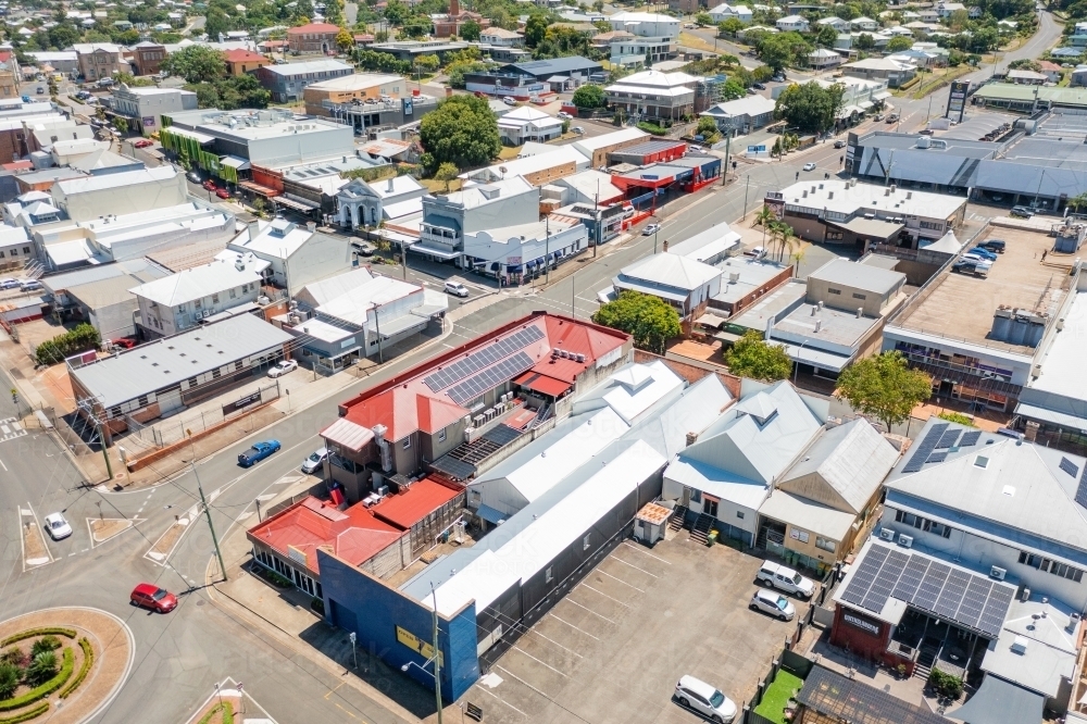 Aerial view of shops and infrastructure in a regional town in daylight - Australian Stock Image