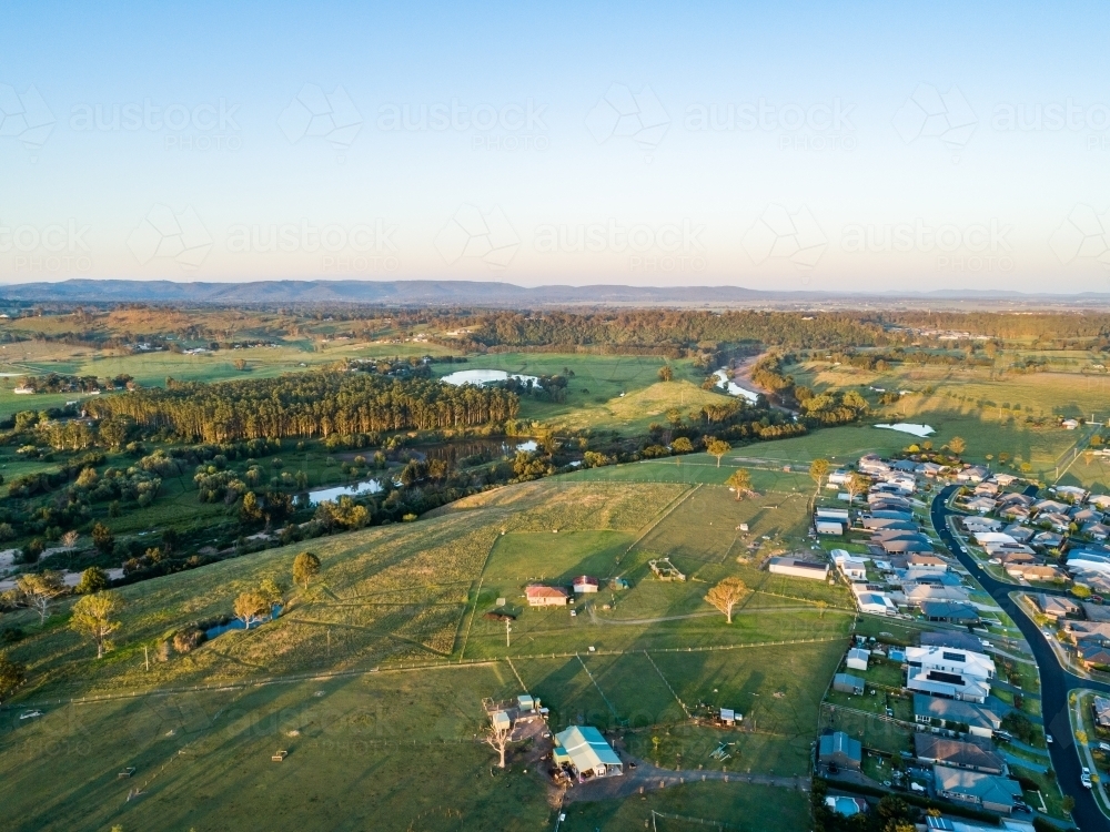 Aerial view of small acreage properties backing onto farmland at edge of town in Hunter Valley - Australian Stock Image