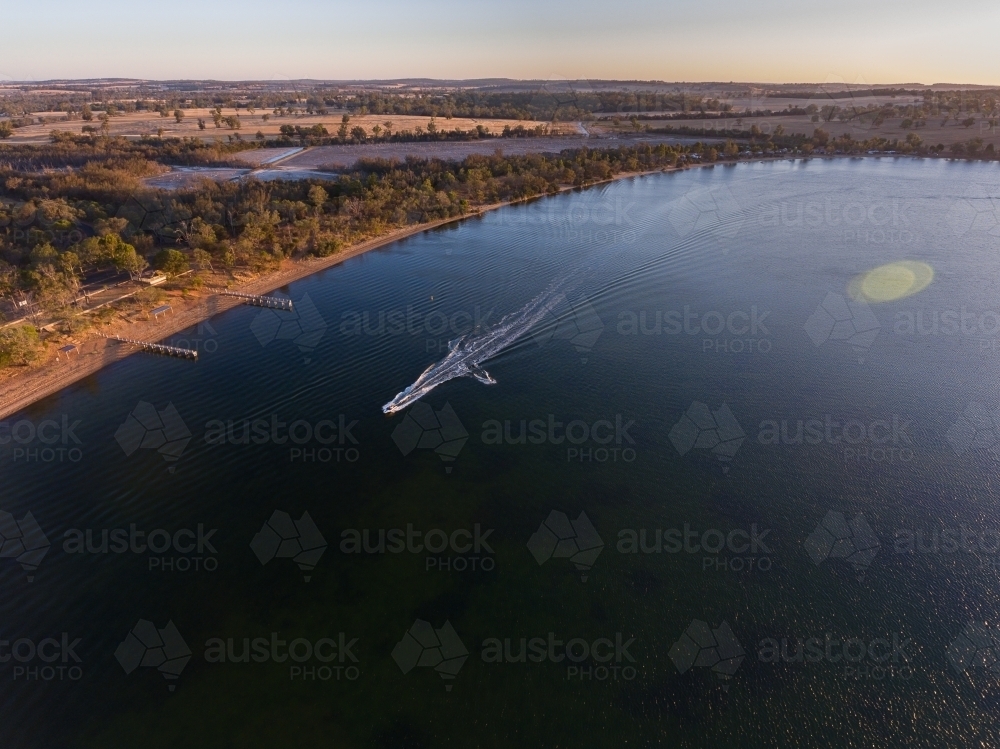 aerial view of speedboat towing skier on lake Towerrinning - Australian Stock Image