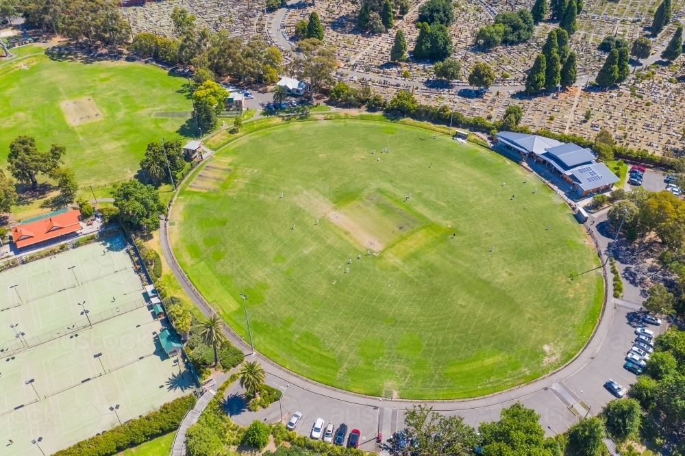 Aerial view of sporting ovals and tennis courts in a city park - Australian Stock Image