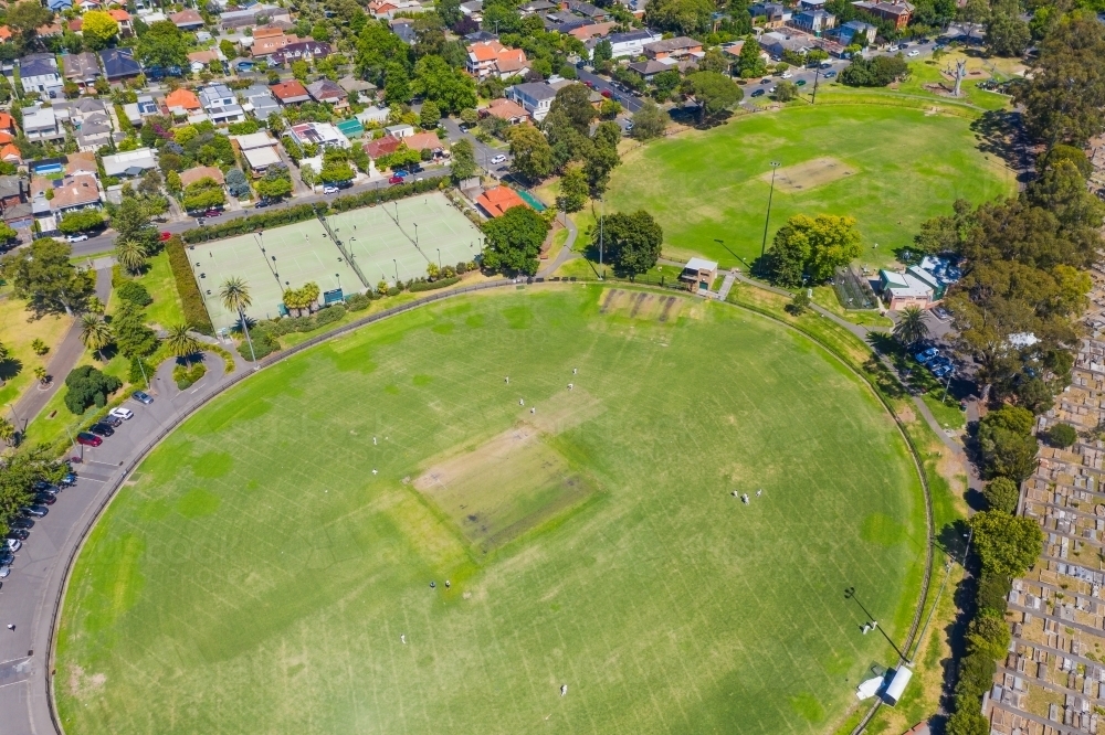 Aerial view of sporting ovals and tennis courts in a city park - Australian Stock Image