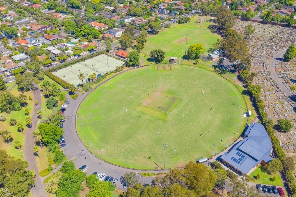 Aerial view of sporting ovals and tennis courts in a city park - Australian Stock Image