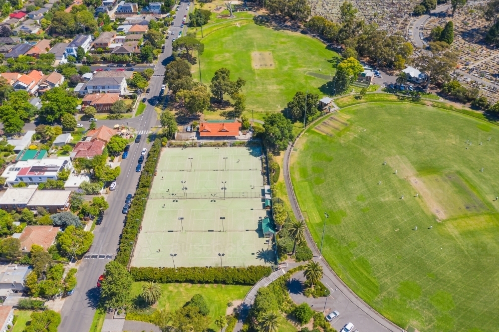 Aerial view of sporting ovals and tennis courts in a city park - Australian Stock Image