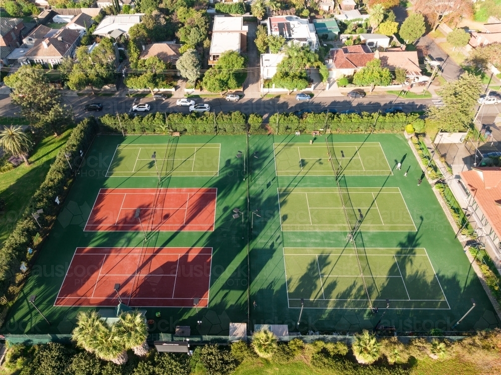Image of Aerial view of suburban courts crossed by long afternoon ...