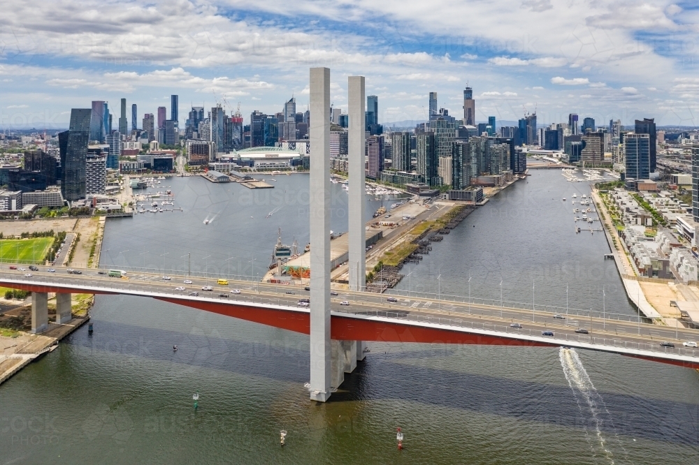 Aerial view of the Bolte Bridge over the Yarra River and Melbourne city skyline in the background - Australian Stock Image