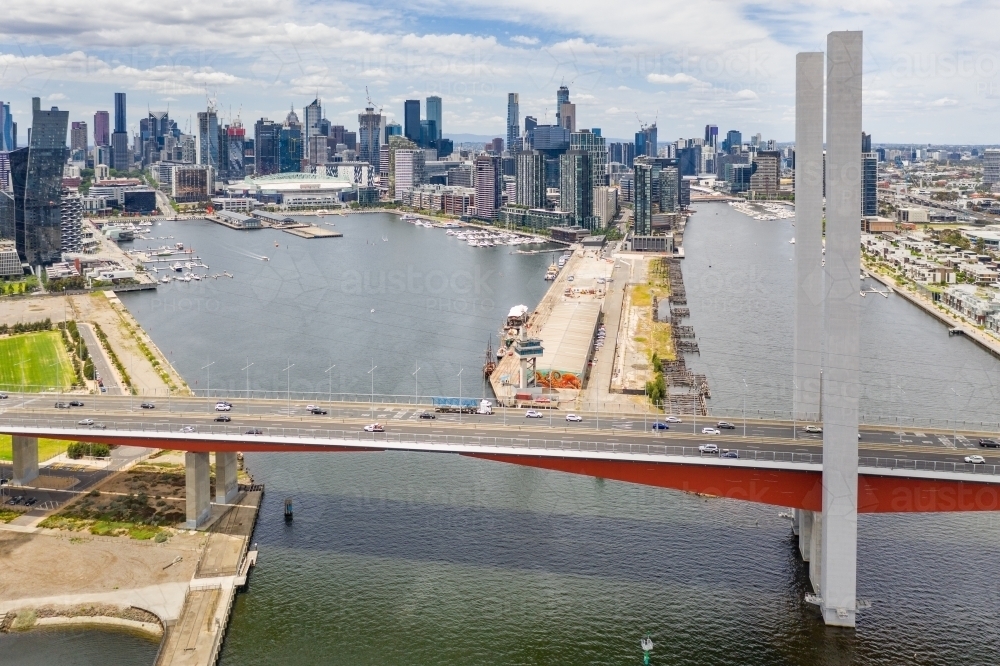 Aerial view of the Bolte Bridge over the Yarra River and Melbourne city skyline in the background - Australian Stock Image