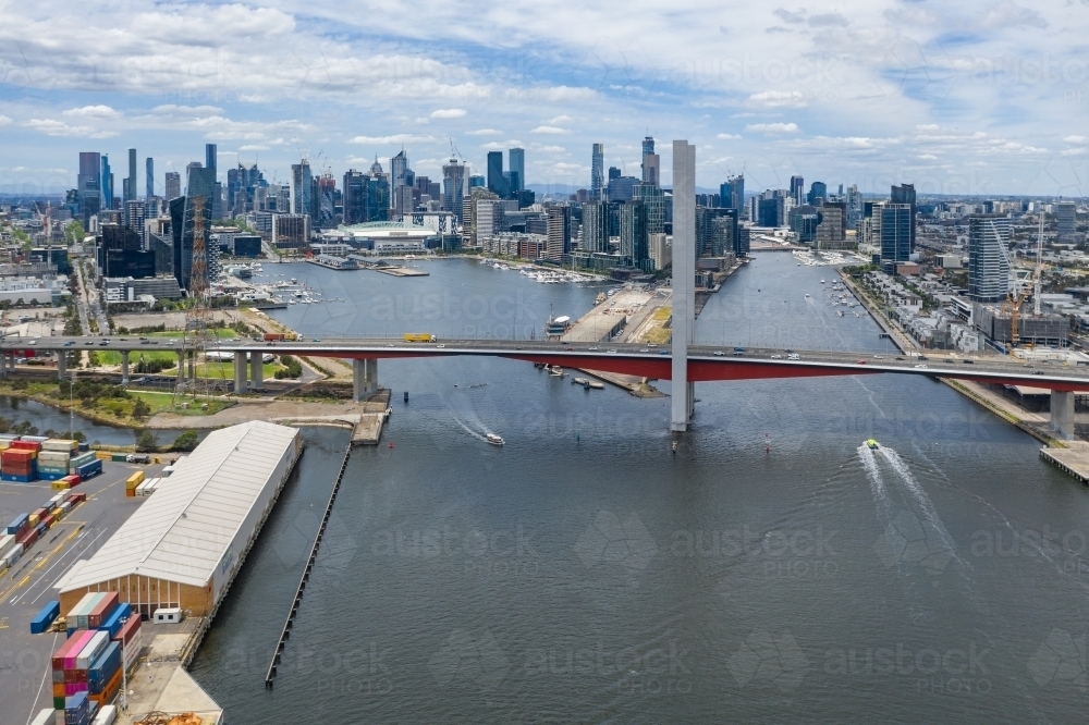 Aerial view of the Bolte Bridge over the Yarra River and Melbourne city skyline in the background - Australian Stock Image