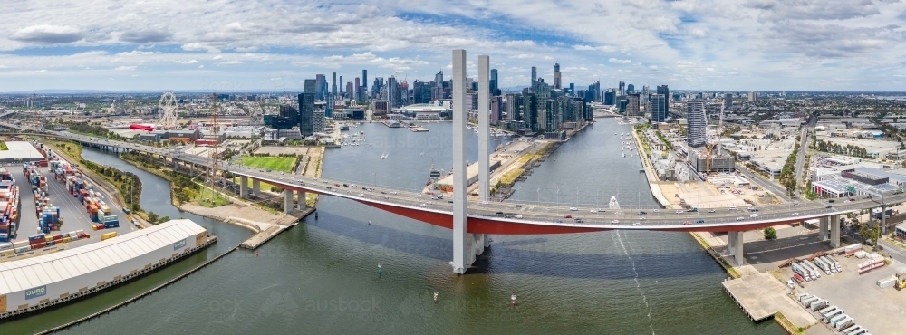 Aerial view of the Bolte Bridge over the Yarra River and Melbourne city skyline in the background - Australian Stock Image