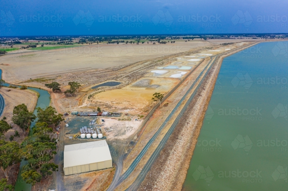 Aerial view of the dam wall and pumping station of a large reservoir. - Australian Stock Image