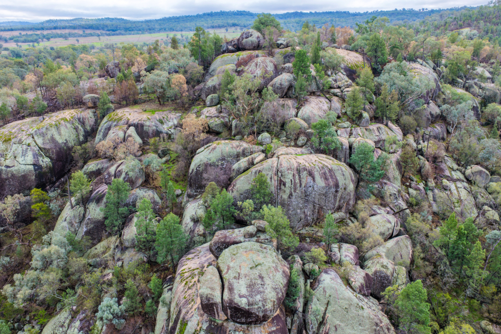 Aerial view of the dramatic granite rock formations and natural landscape at Cranky Rock Reserve - Australian Stock Image