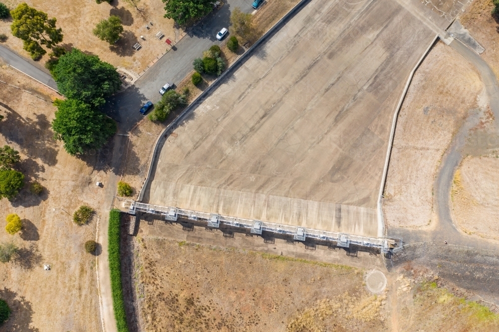 Aerial view of the dry concrete spillway of a reservoir - Australian Stock Image