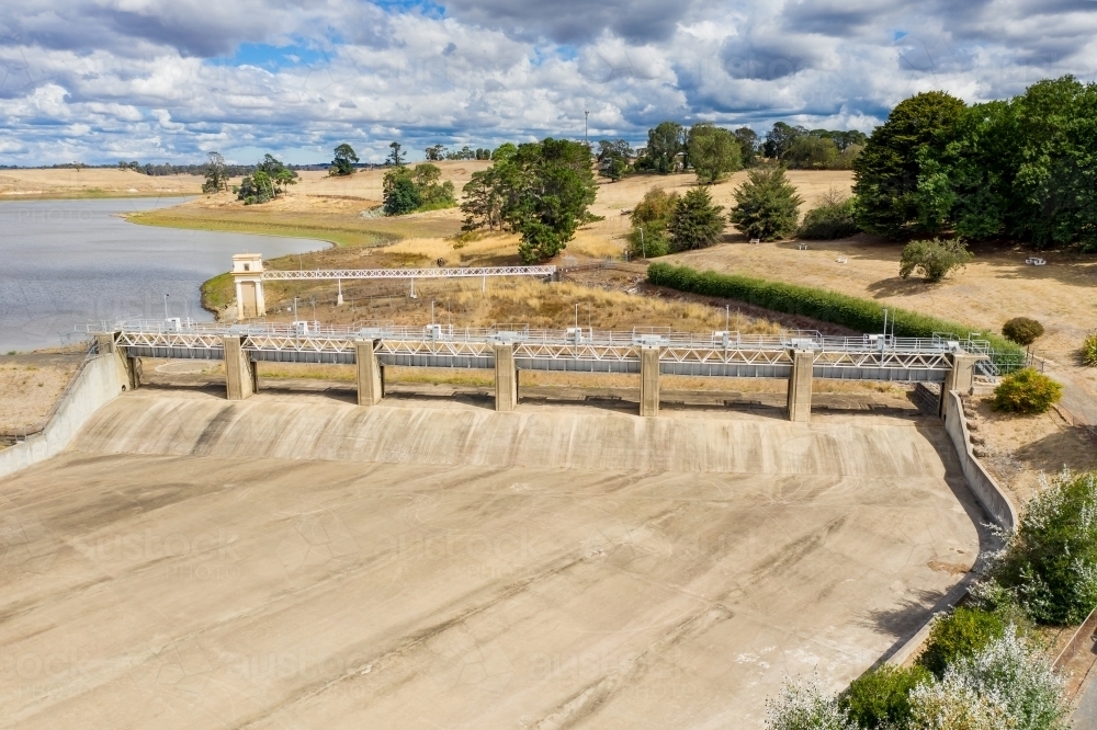 Aerial view of the dry concrete spillway of a reservoir - Australian Stock Image