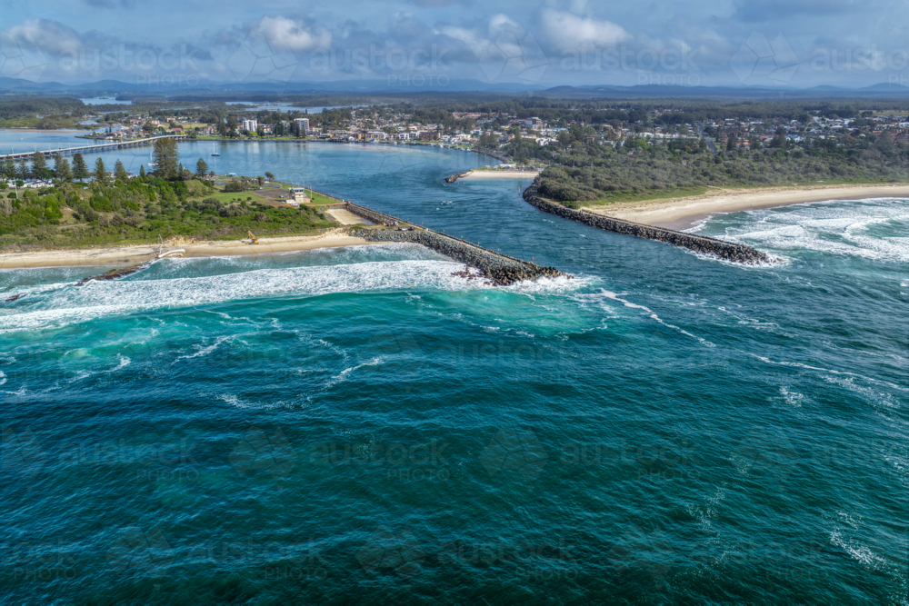 Aerial view of the Forster and Tuncurry breakwalls with the bridge spanning Wallis Lake - Australian Stock Image