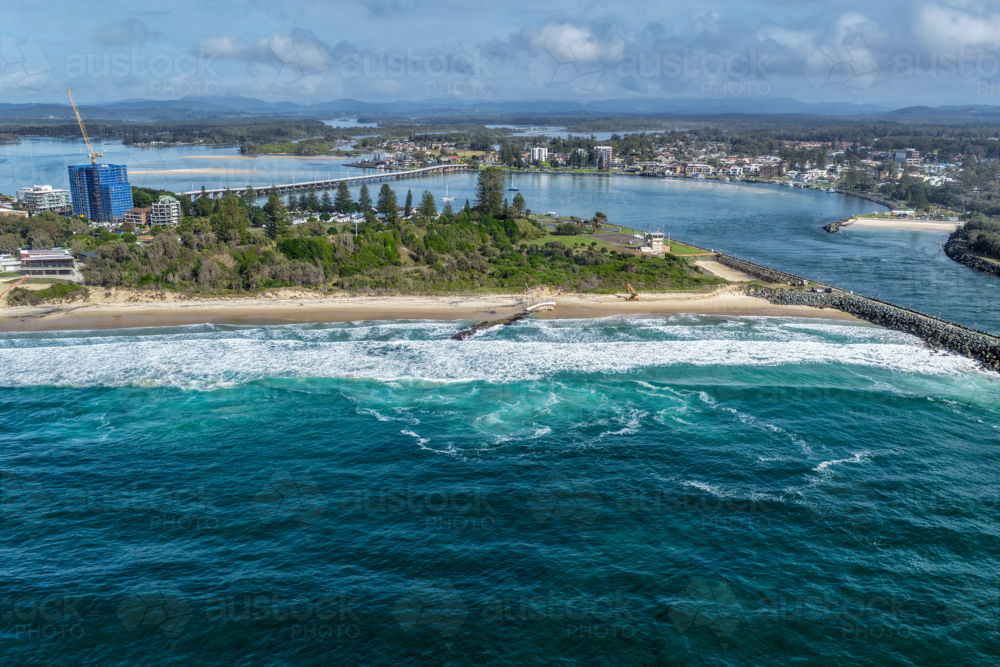Aerial view of the Forster and Tuncurry breakwalls with the bridge spanning Wallis Lake - Australian Stock Image