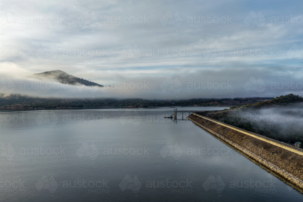 Aerial view of the Glenbawn Dam wall featuring the water intake system and servicing pontoon - Australian Stock Image