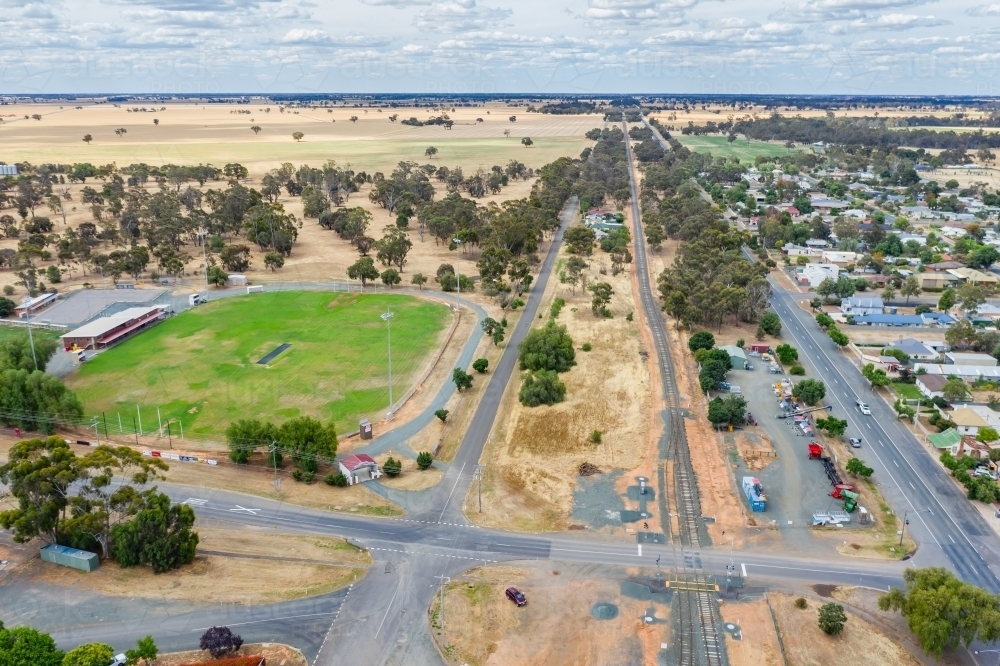 Aerial view of the main road through a country town and a football oval - Australian Stock Image
