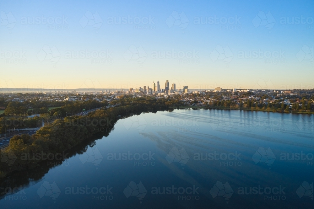 Aerial view of the Mitchell Freeway and Lake Monger looking towards the Perth City skyline - Australian Stock Image