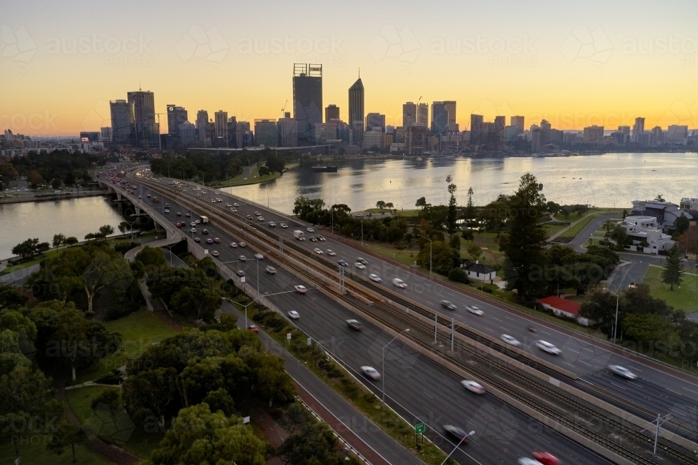 Aerial view of the Perth City skyline and Narrows Bridge at dawn on a peaceful morning. - Australian Stock Image