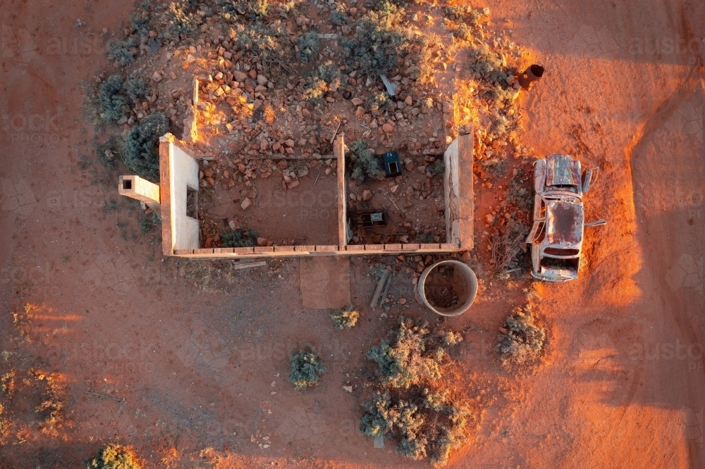 Aerial view of the shell of an old house and car wreck alongside - Australian Stock Image