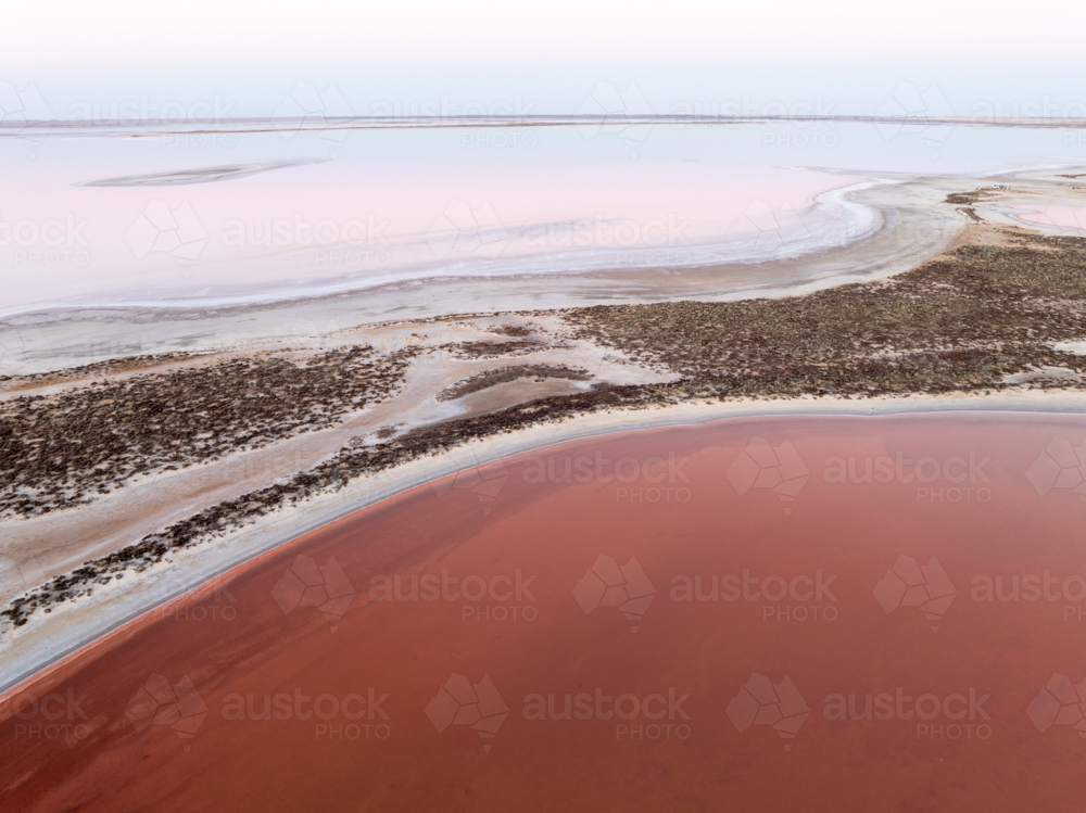 Aerial view of the shoreline of a pink salt lake - Australian Stock Image
