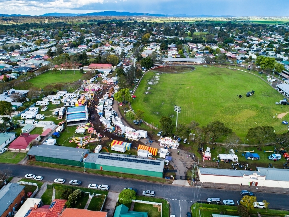 Aerial view of the showring and sideshow alley at agricultural show fairground - Australian Stock Image