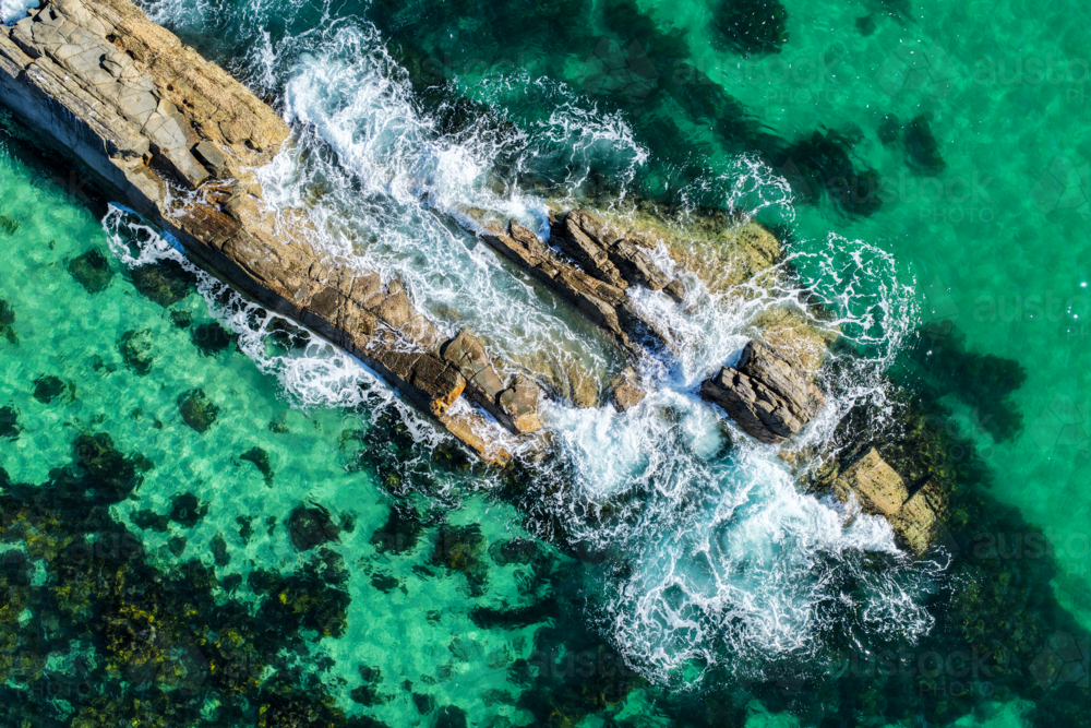 Aerial view of The Tanks in Forster, showcasing the iconic rock formations and clear waters - Australian Stock Image