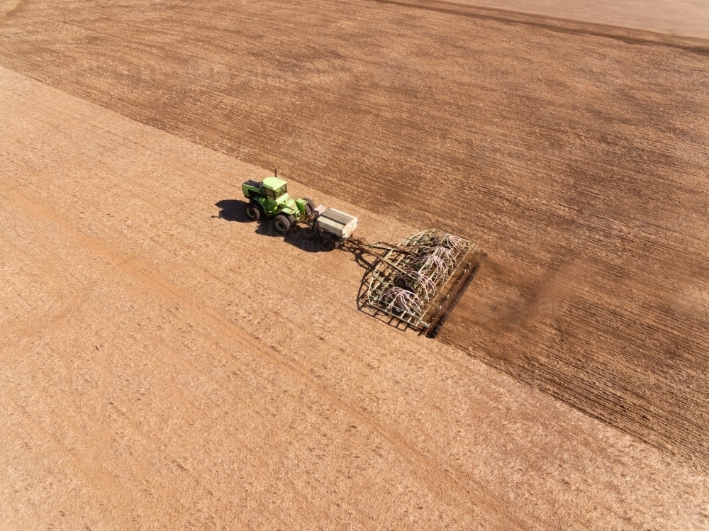 Aerial view of tractor and seeding bar planting crop - Australian Stock Image