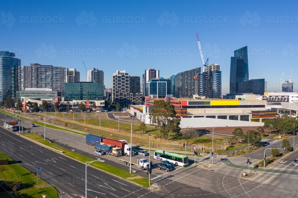 Aerial view of traffic stopped at a busy city intersections and high rise buildings behind - Australian Stock Image