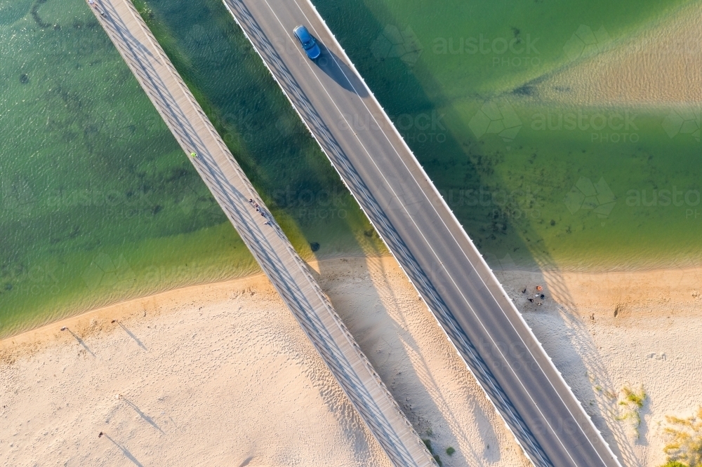 Aerial view of two bridges crossing a coastal river and sandy beach - Australian Stock Image