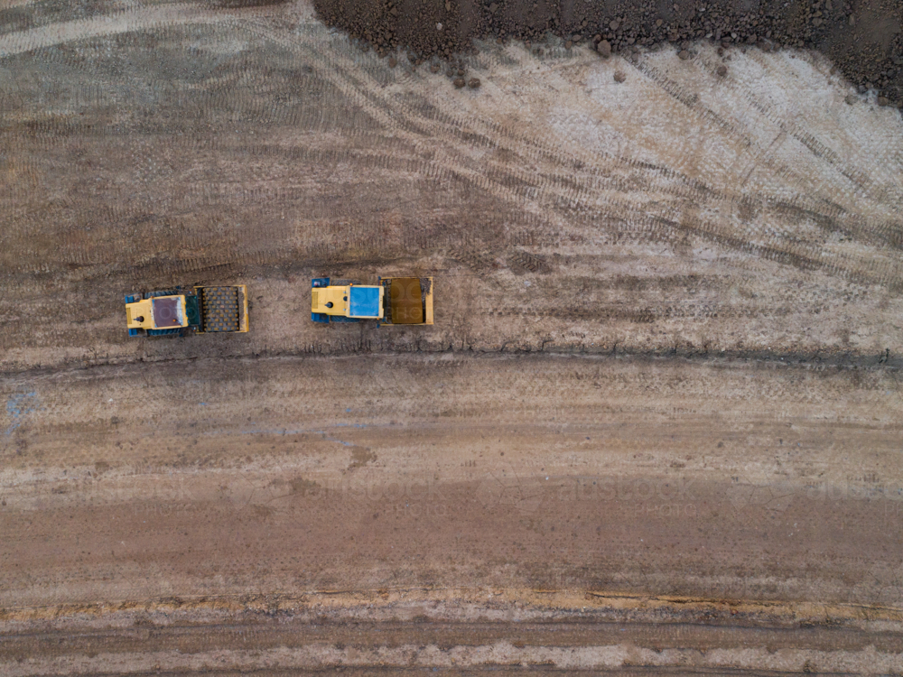 Aerial view of two heavy machinery vehicles for earthworks on construction site for Singleton Bypass - Australian Stock Image