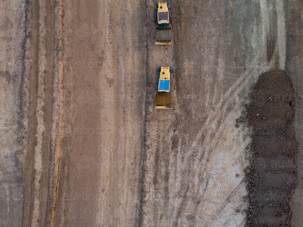 Aerial view of two heavy machinery vehicles for earthworks on construction site for Singleton Bypass - Australian Stock Image